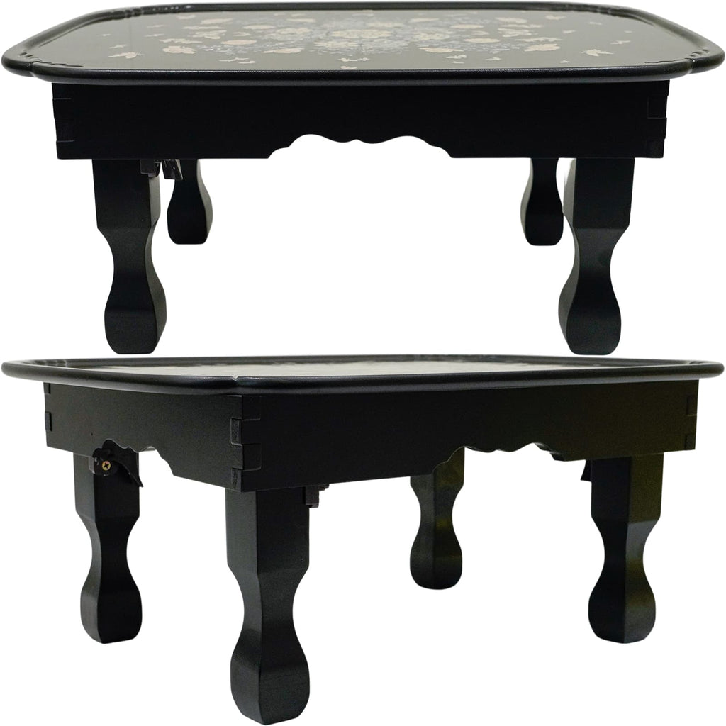 Black table with mother-of-pearl floral inlay.