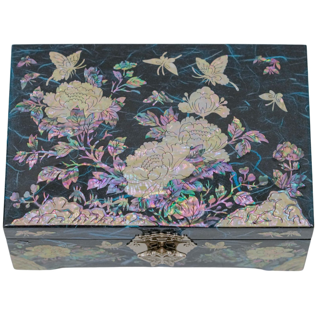 A decorative blue jewelry box with a radiant mother-of-pearl inlay showcasing cranes and floral designs, detailed with a butterfly clasp.