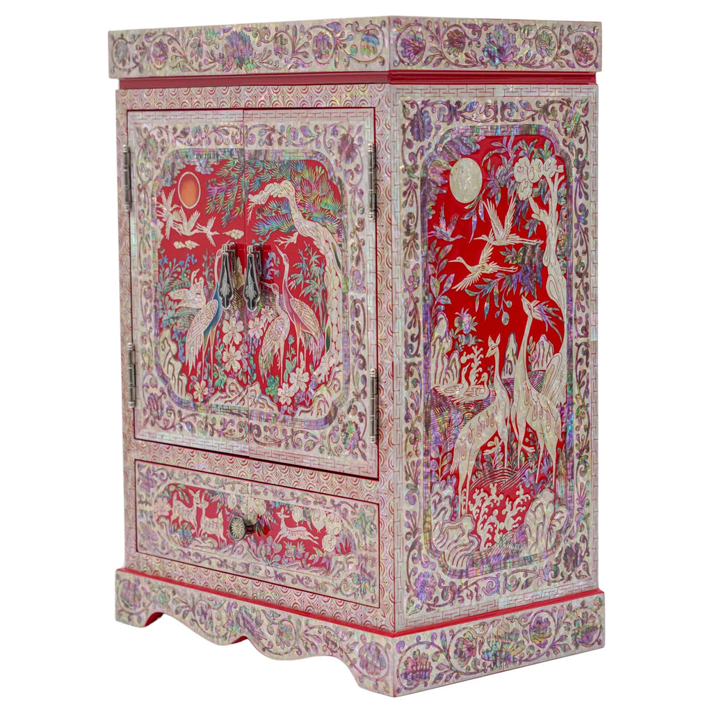 An elaborately decorated red and multicolored cabinet with traditional Asian motifs, featuring cranes and floral patterns, with brass hardware.An elaborately decorated red and multicolored cabinet with traditional Asian motifs, featuring cranes and floral patterns, with wooden jewelry box