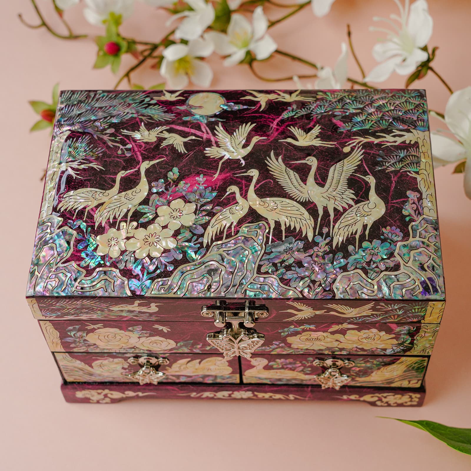 Angled jewelry box photo with floral backdrop; cranes and peonies in mother-of-pearl