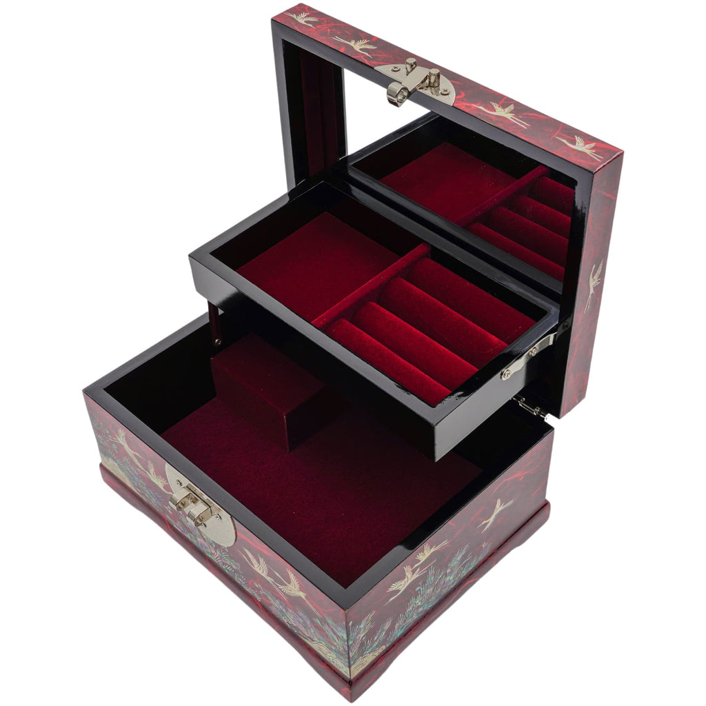 An open jewelry box with red velvet lining and Mother of Pearl inlay on the exterior, featuring multiple compartments for storage.