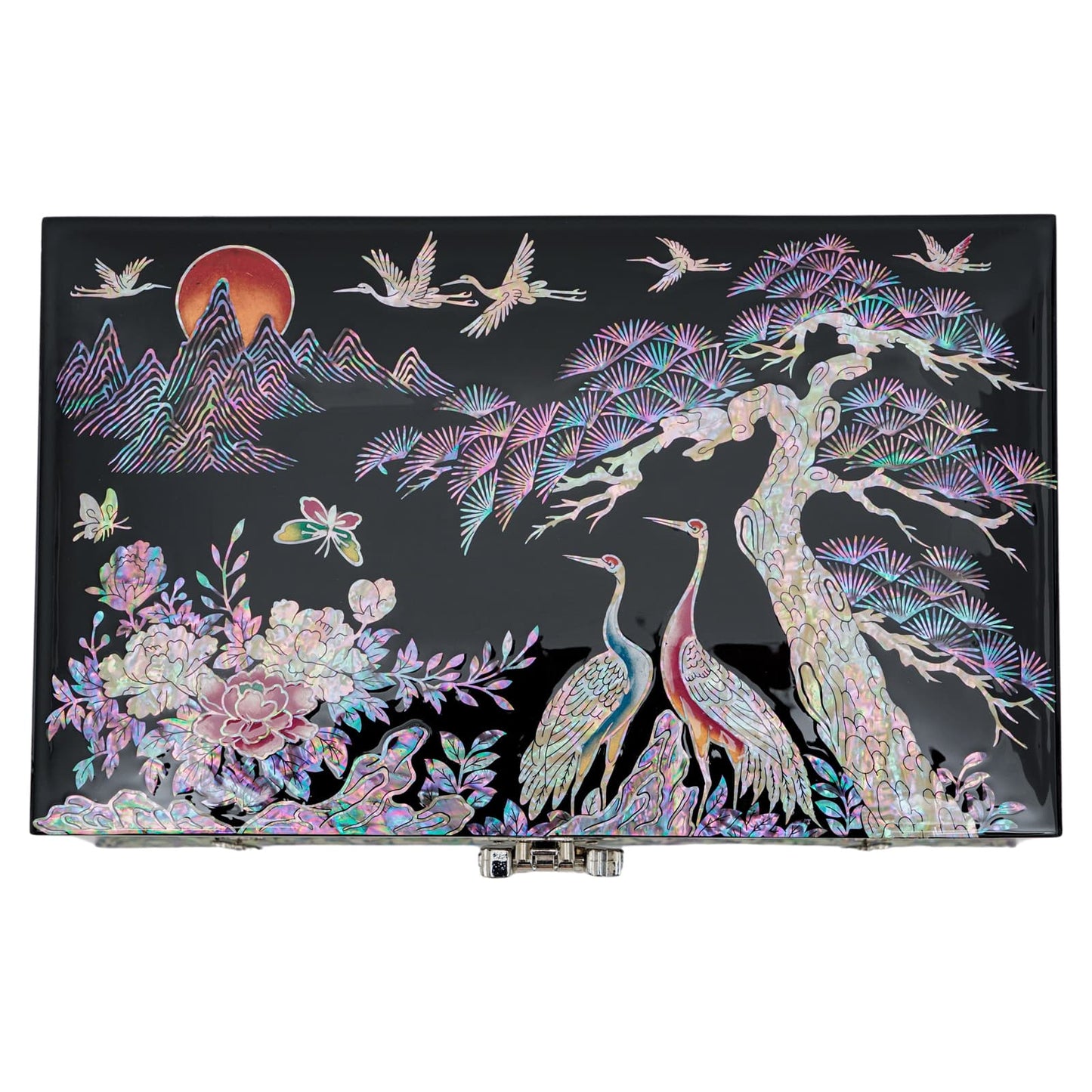 A rectangular black lacquer box with mother-of-pearl inlay depicting cranes and a pine tree against a stylized mountainous background with a rising sun, showing a fusion of vibrant colors and traditional Korean art.