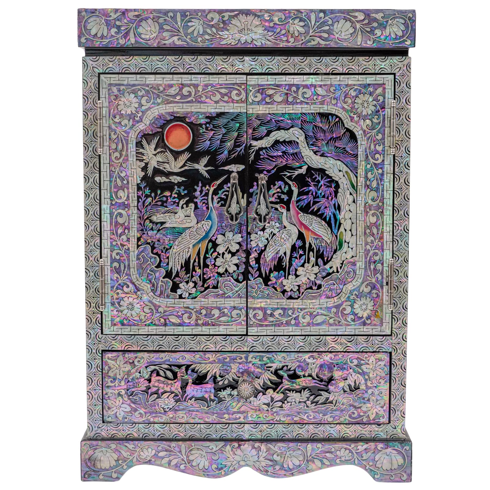 A traditional mother-of-pearl cabinet with intricate cranes and trees design, featuring a red sun motif and elaborate borders.