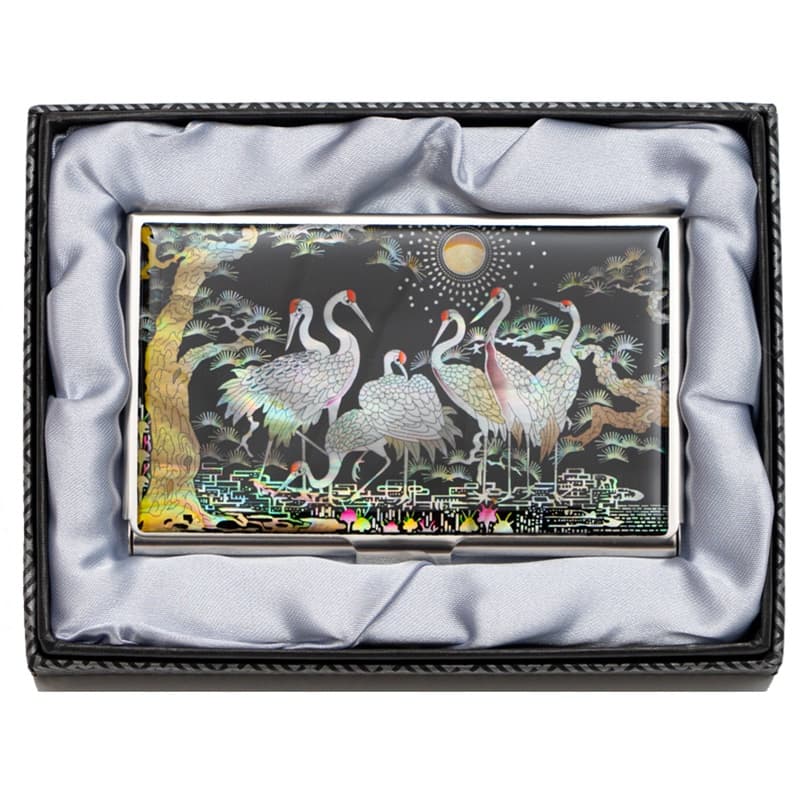 An open, metal business card case featuring a mirror on the interior of the lid and a mesh card holder, against a white backdrop.