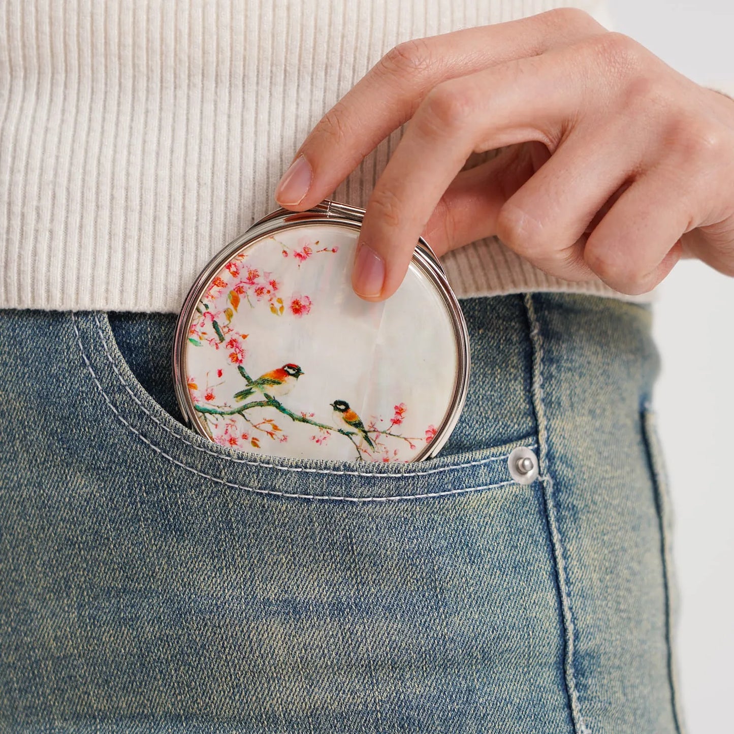 Bird-and-blossom mirror in denim pocket