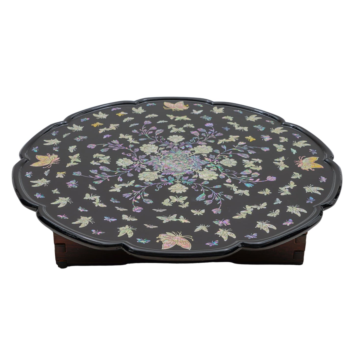Black round table with scalloped edges, featuring intricate mother-of-pearl inlay of flowers and butterflies
