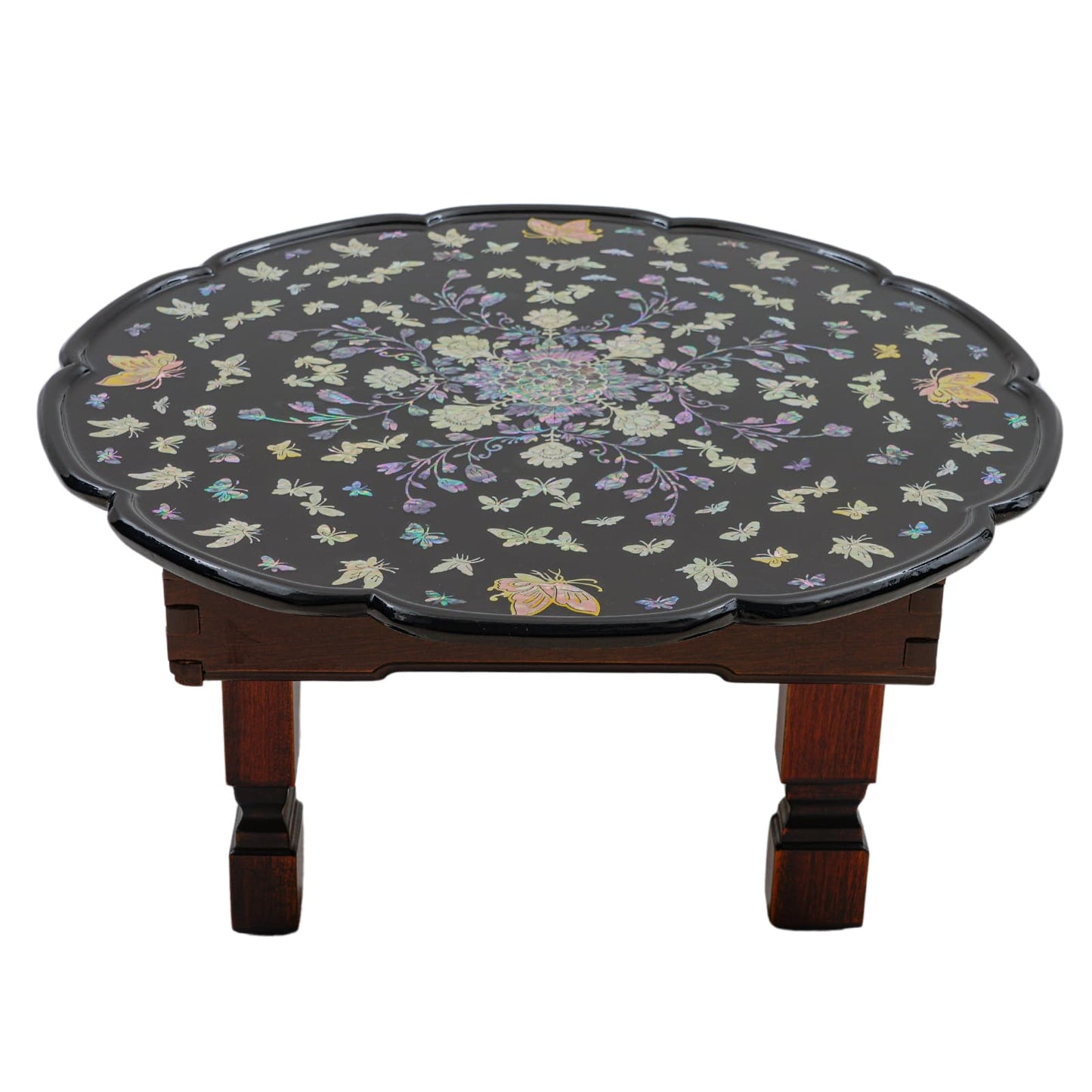 Black round table with scalloped edges, featuring mother-of-pearl inlay of flowers and butterflies.