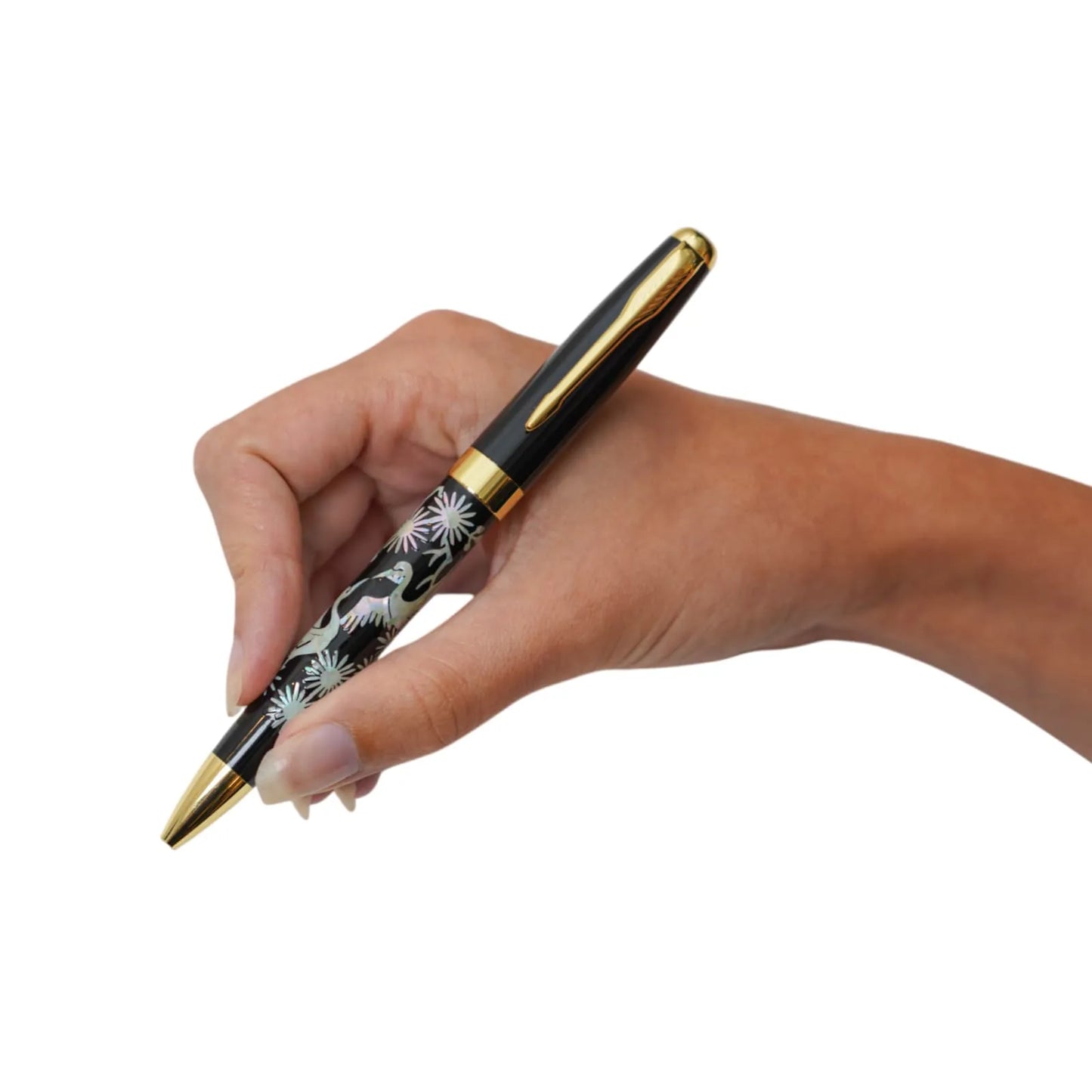 Black crane pen with floral design held in writing position