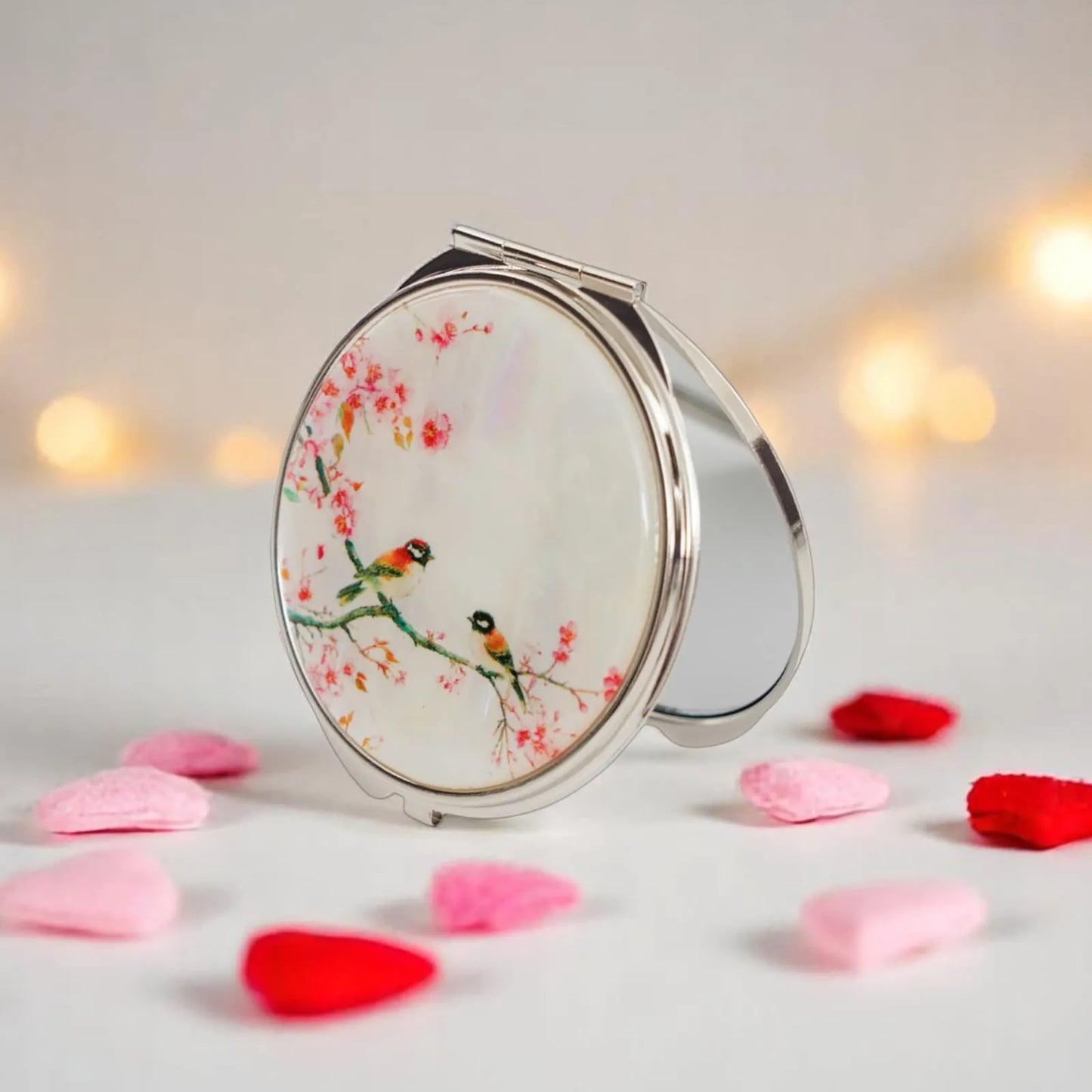 Cherry blossom bird compact mirror in satin box with plant in background