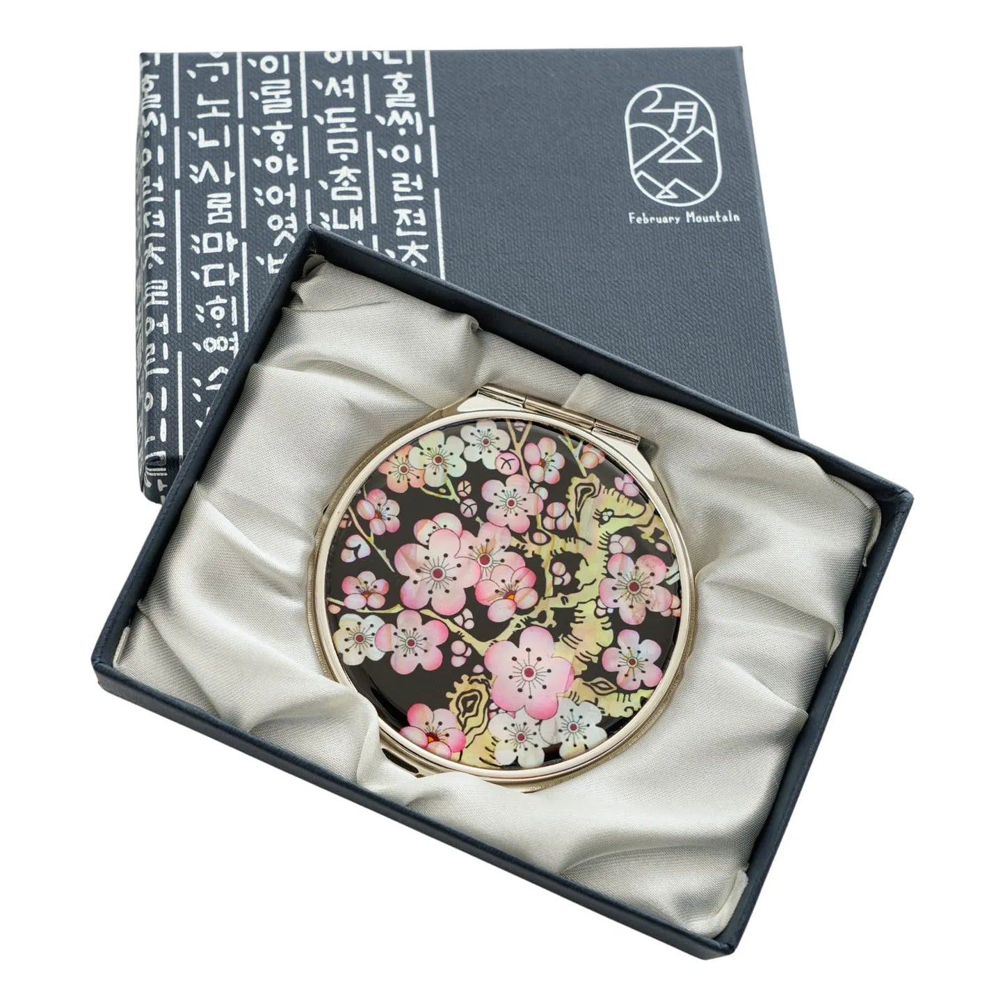 Compact mirror featuring a cherry blossom design on a black mother-of-pearl background in a gift box
