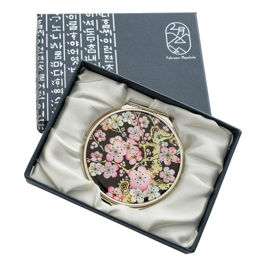 Compact mirror featuring a cherry blossom design on a black mother-of-pearl background in a gift box