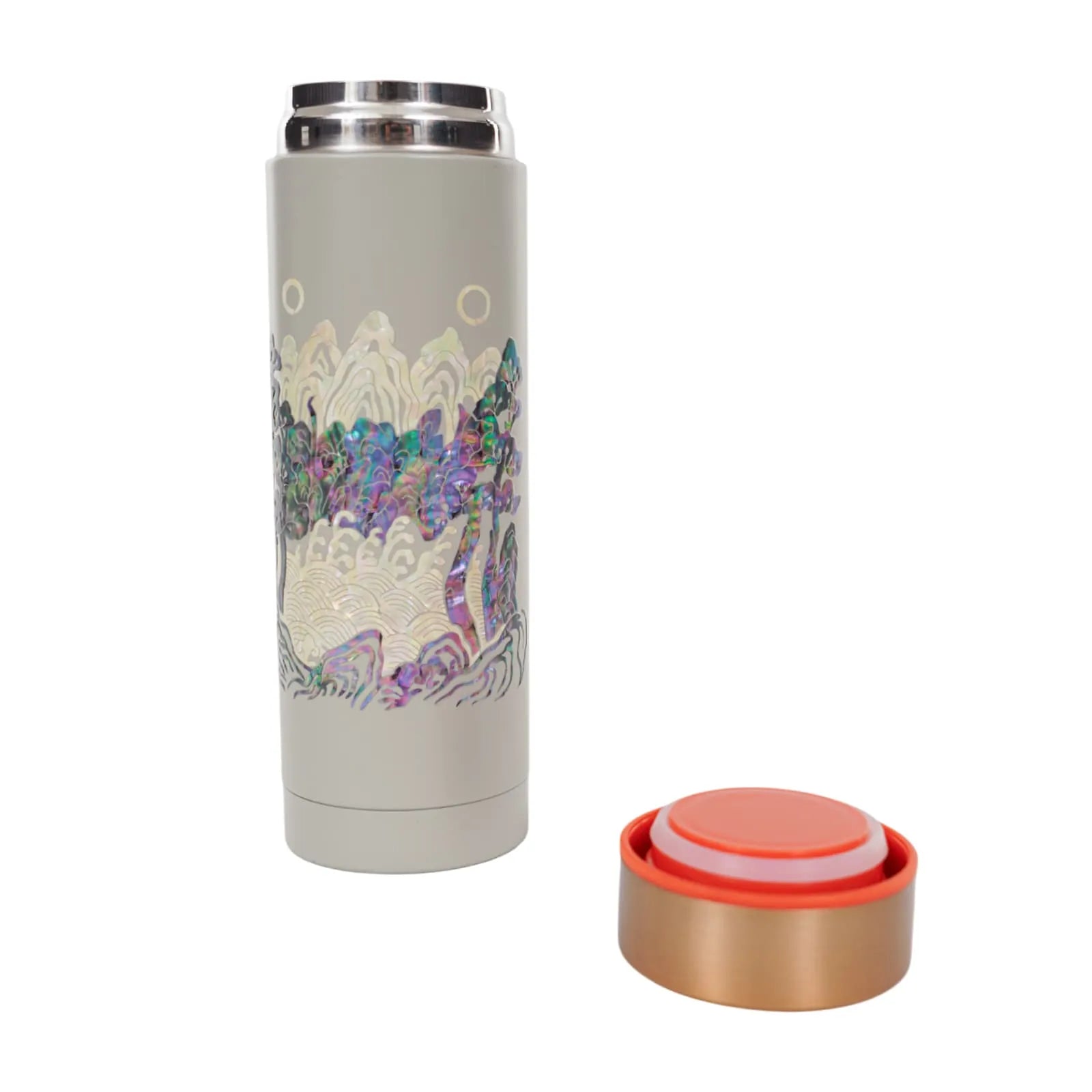 Gray tumbler with iridescent landscape design, lid placed next to it