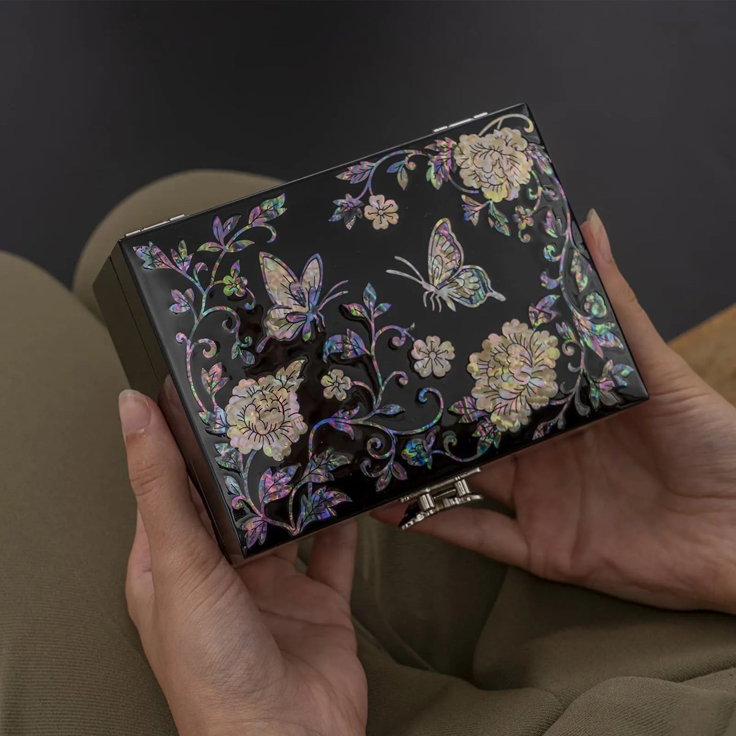 Holding rectangular jewelry box with butterfly and peony inlay