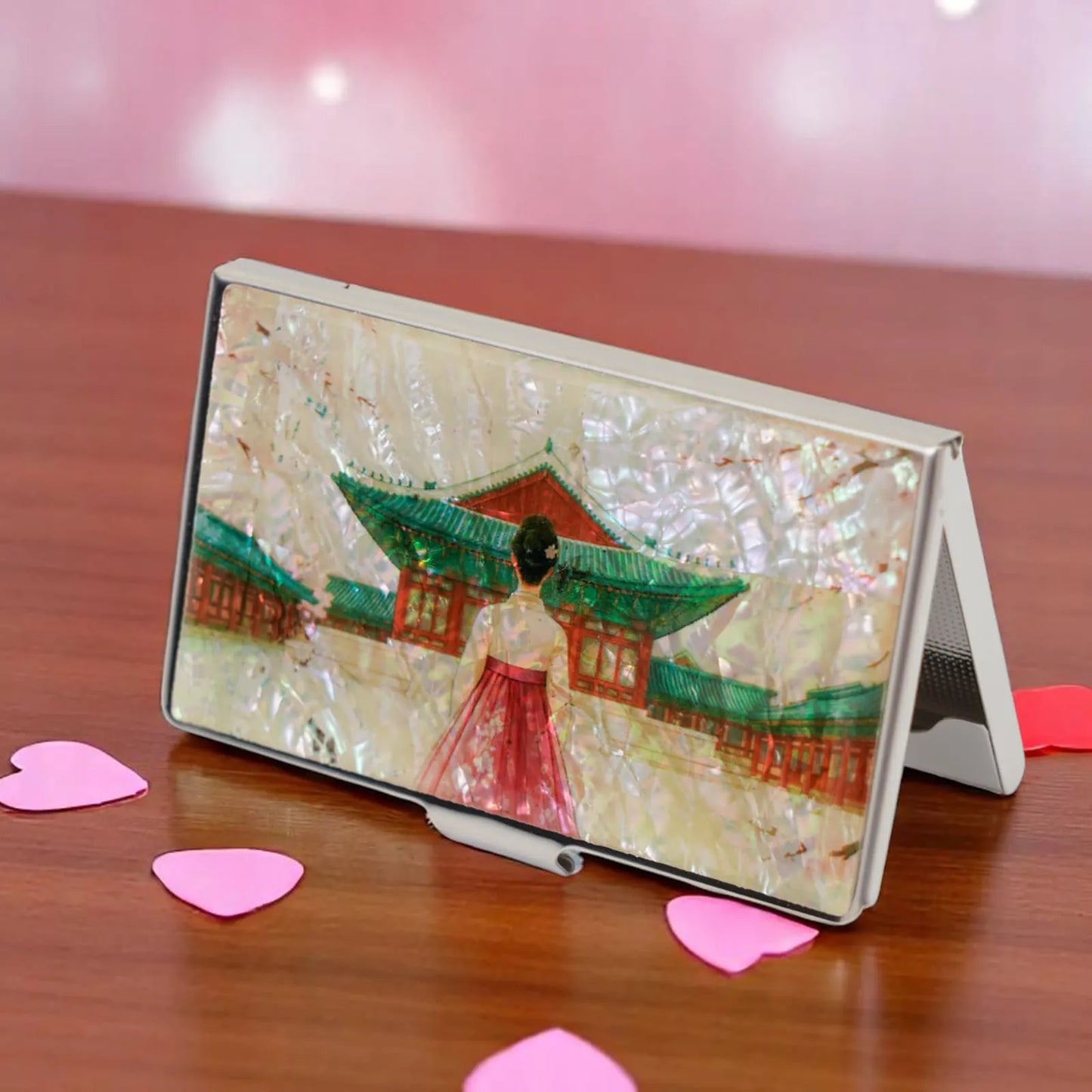 Korean palace card case standing open on table with heart confetti