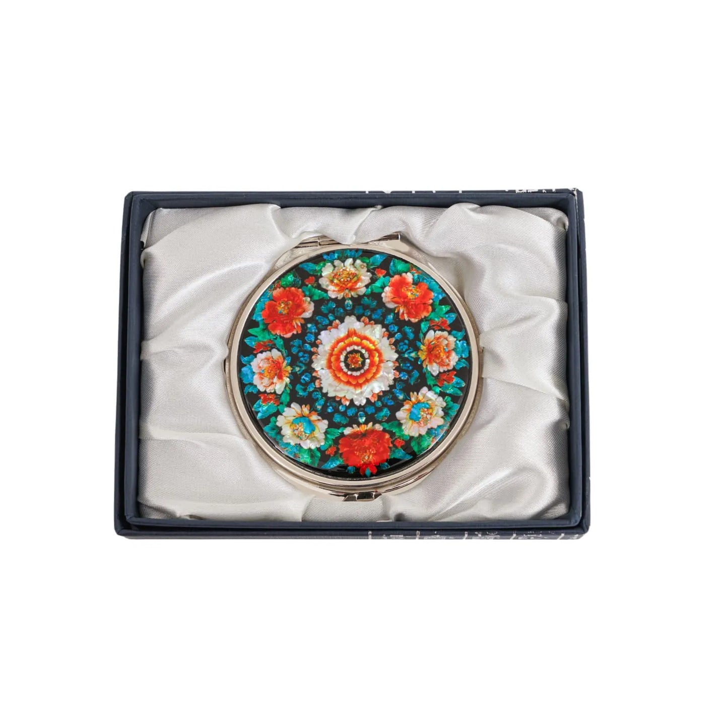 Mirror with bold flower pattern shown in silk-lined box