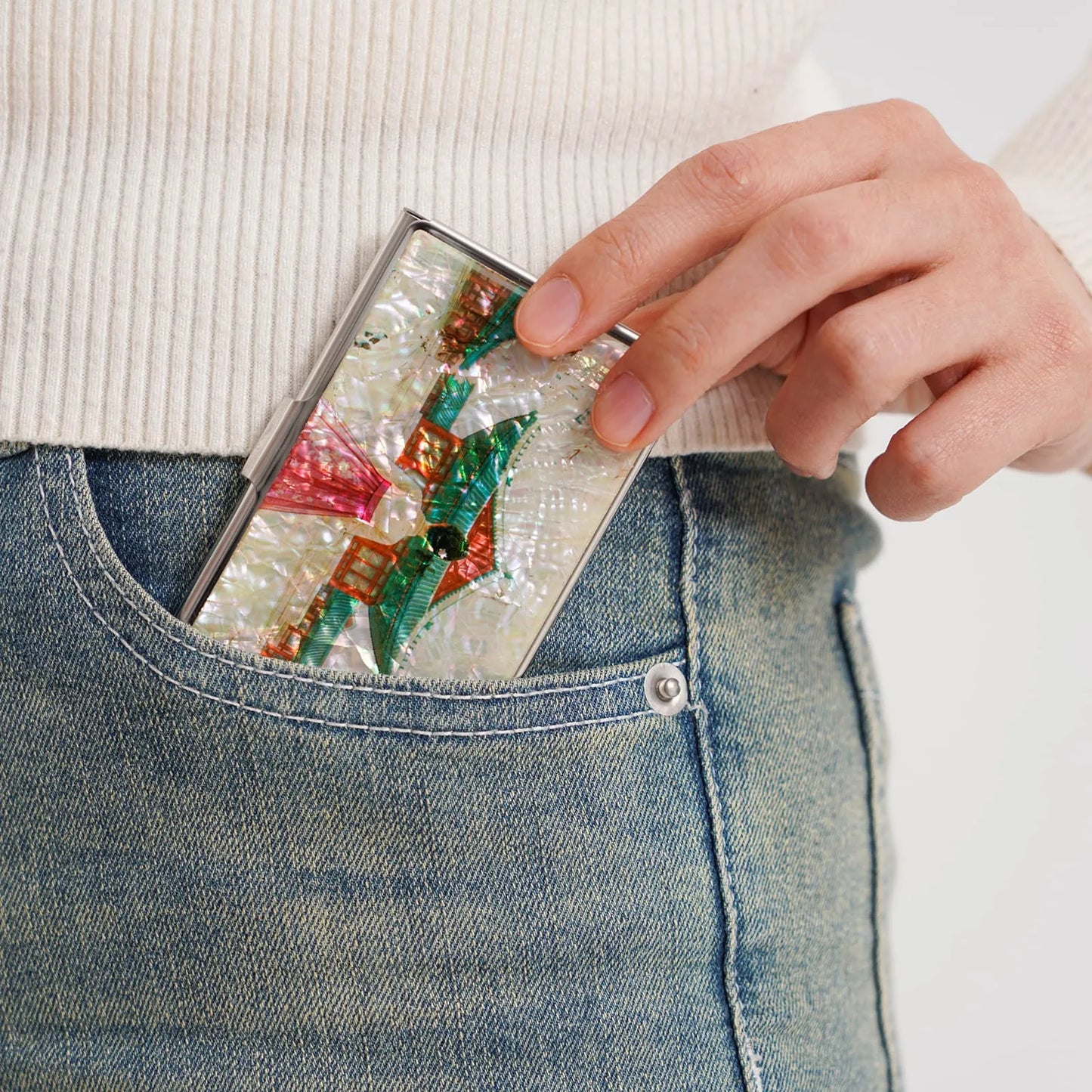 Mother-of-pearl card case with palace design in pocket of jeans