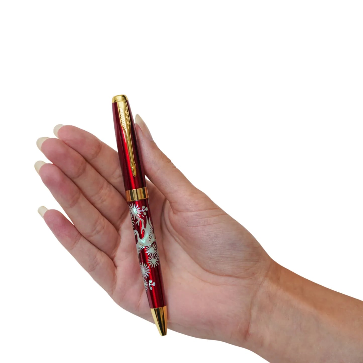 Red crane pen with gold clip held in hand, close-up view
