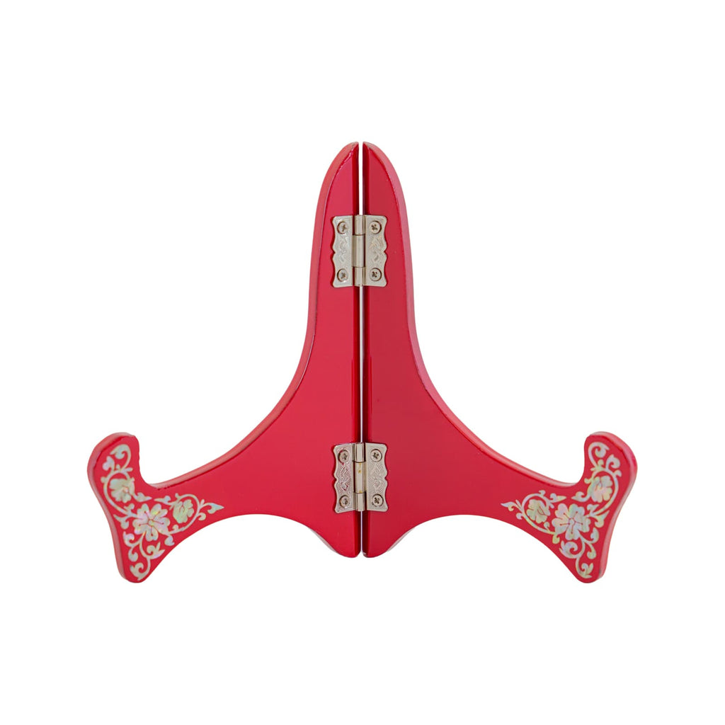 Red lacquered plate stand with mother-of-pearl inlay and metal hinges, designed to hold and display decorative plates