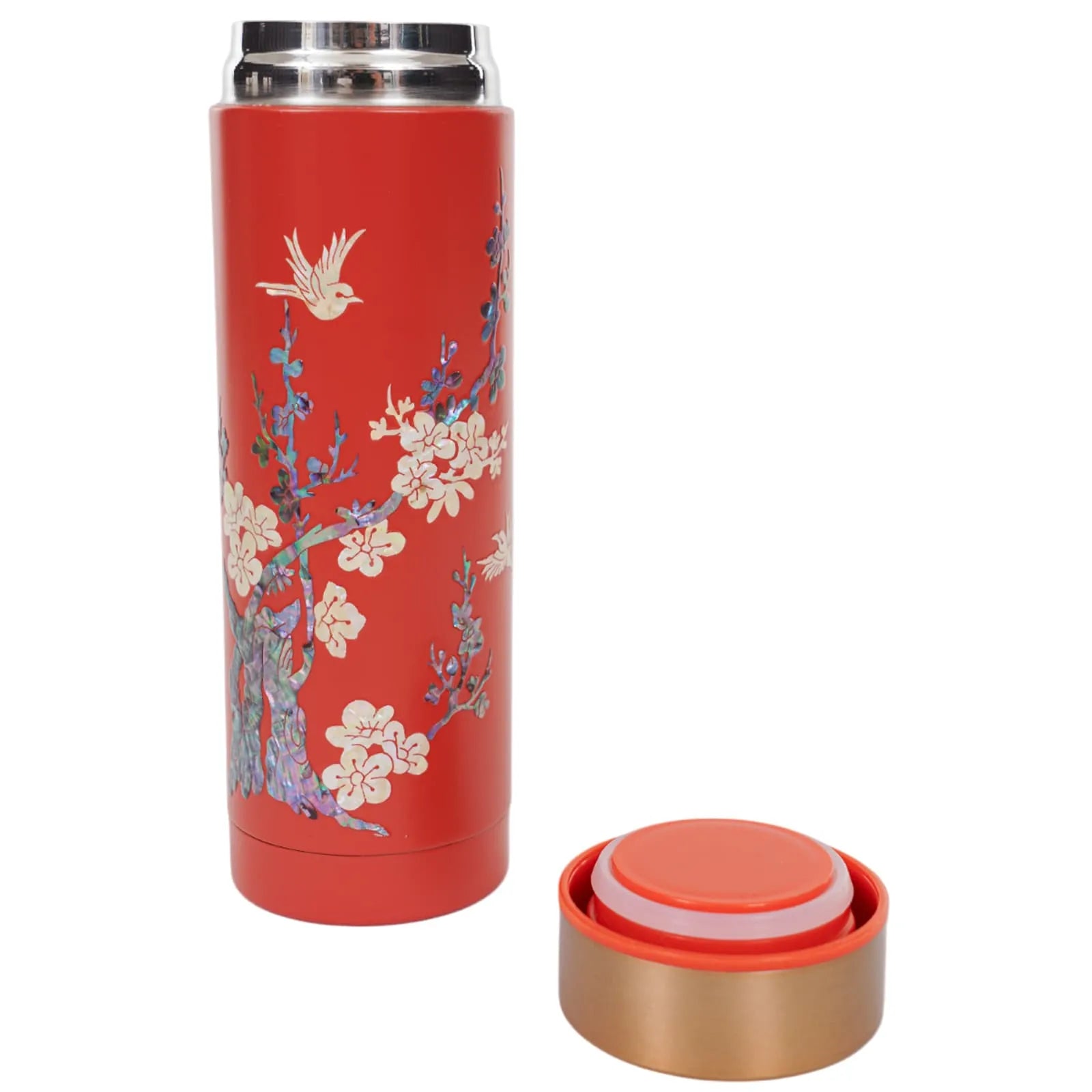 Red tumbler with plum blossom design and separated bronze lid beside it