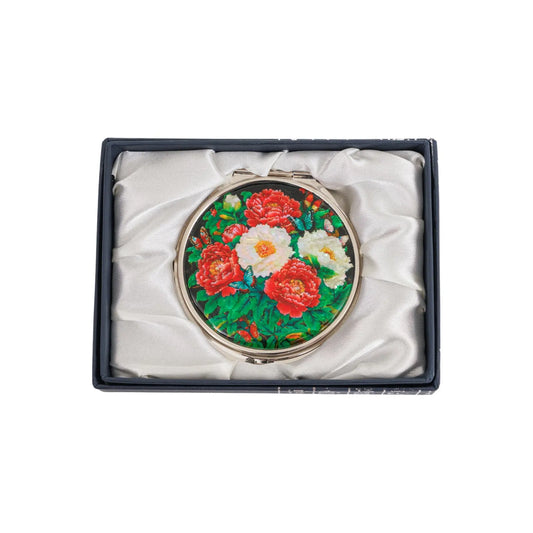 Round peony compact mirror in a silk-lined box, top-down product view