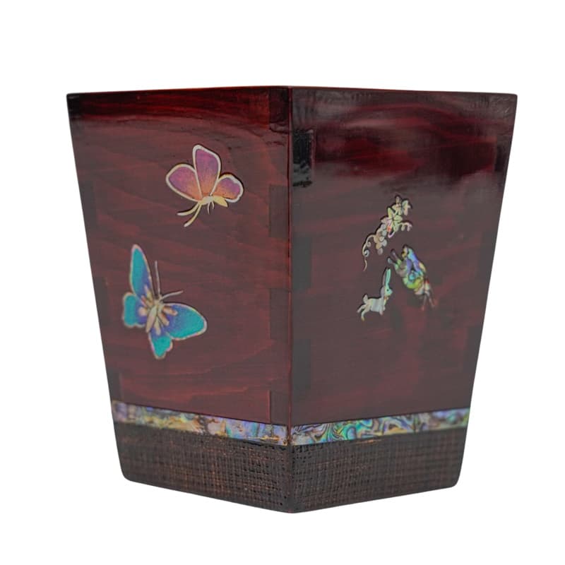 The image shows a wooden pen holder with a dark finish, adorned with mother-of-pearl inlay featuring butterflies and floral patterns.