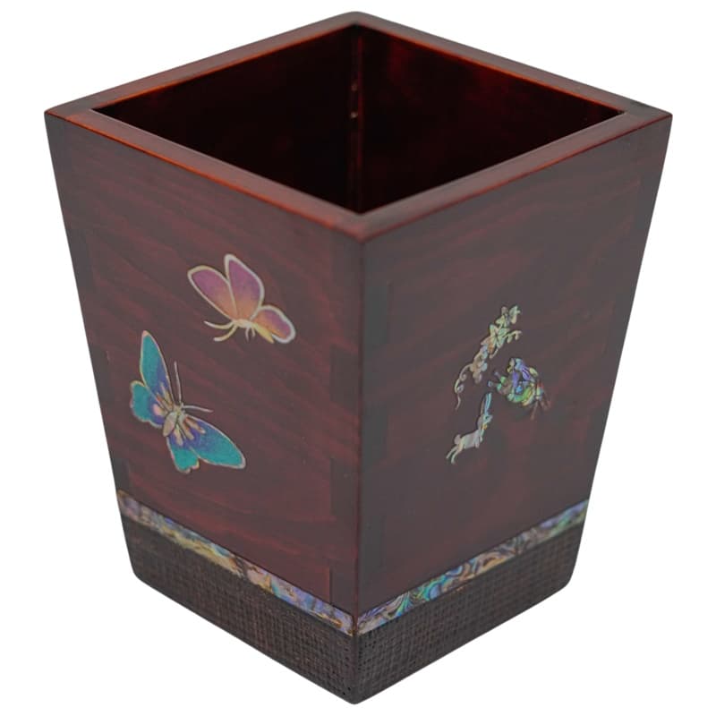This image displays a wooden square pen holder with mother-of-pearl inlay depicting butterflies and floral designs on its side.