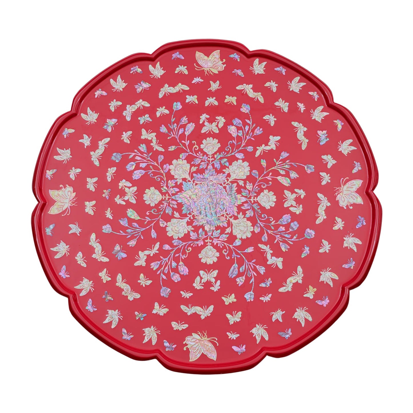 Top view of a red round table with scalloped edges, featuring intricate mother-of-pearl inlay of flowers and butterflies.