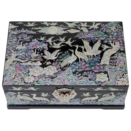 Top view of closed black wooden chest with iridescent mother of pearl crane and pine design, handmade gift for anniversary