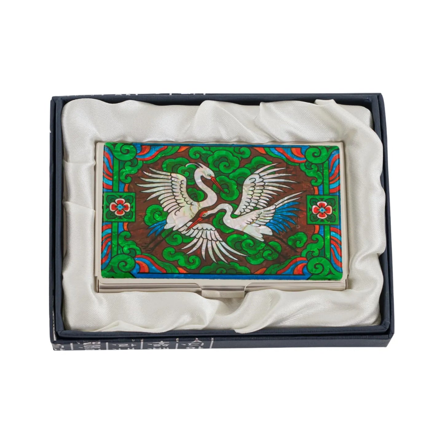 Top view of crane card case resting in silk-lined box for presentation or gift