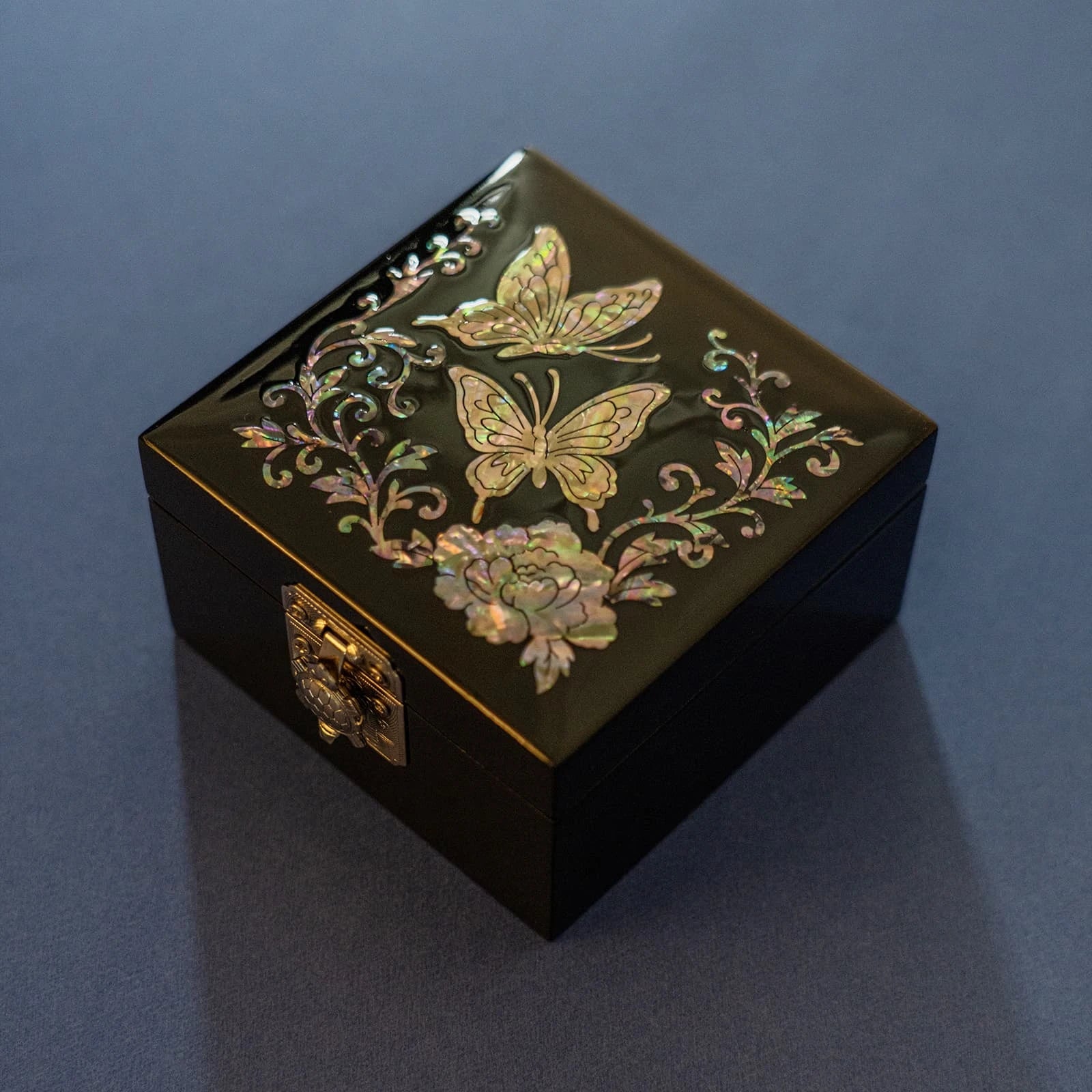 Butterfly and peony mother-of-pearl box on dark blue backdrop