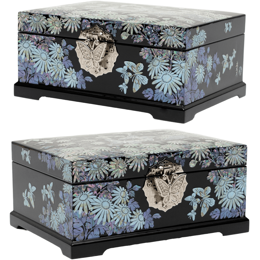  Side and 45-degree angle views of a black jewelry box with mother-of-pearl inlay depicting chrysanthemums and butterflies, featuring detailed metal clasps.
