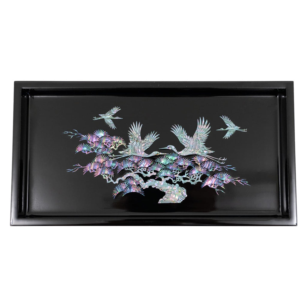 The image displays a tray with a black background and a colorful mother-of-pearl design featuring cranes and pine trees