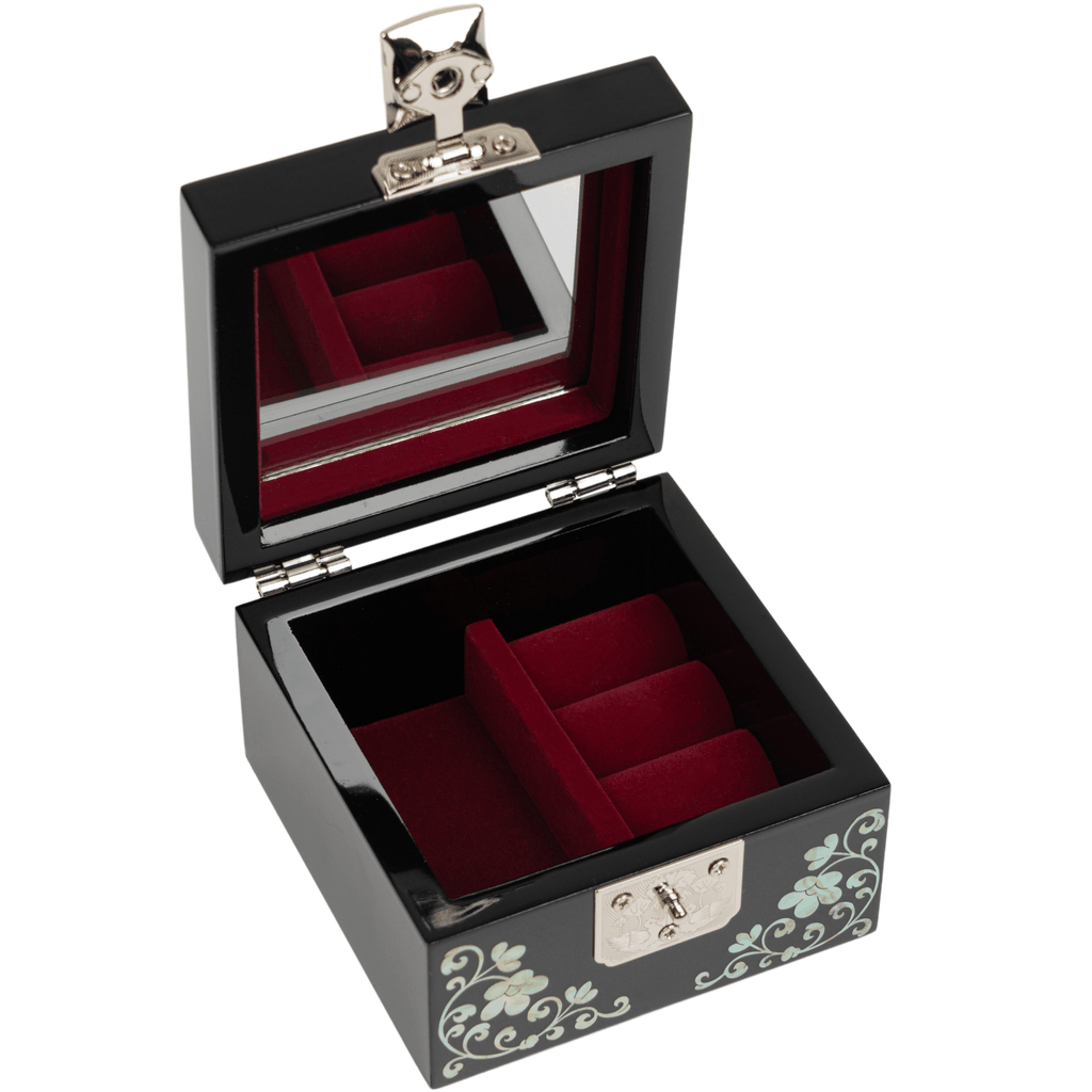 An open black jewelry box with a mirrored lid and plush red velvet interior, featuring mother-of-pearl floral inlay on the front.