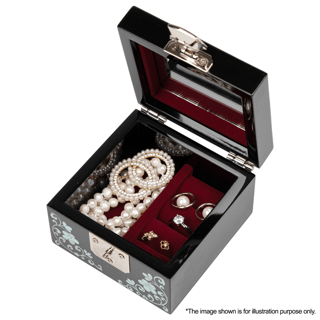 An open black jewelry box with a mirrored lid and red velvet interior, filled with pearls and rings, featuring mother-of-pearl inlay on the exterior. Image for illustration only.