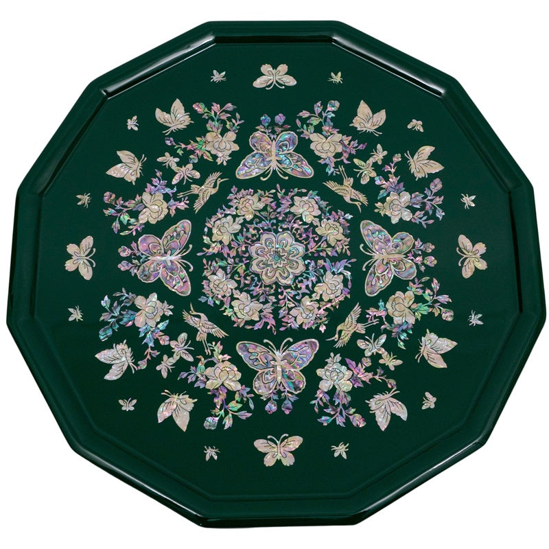 An octagonal tray with mother-of-pearl inlay featuring butterflies and flowers on a green background.