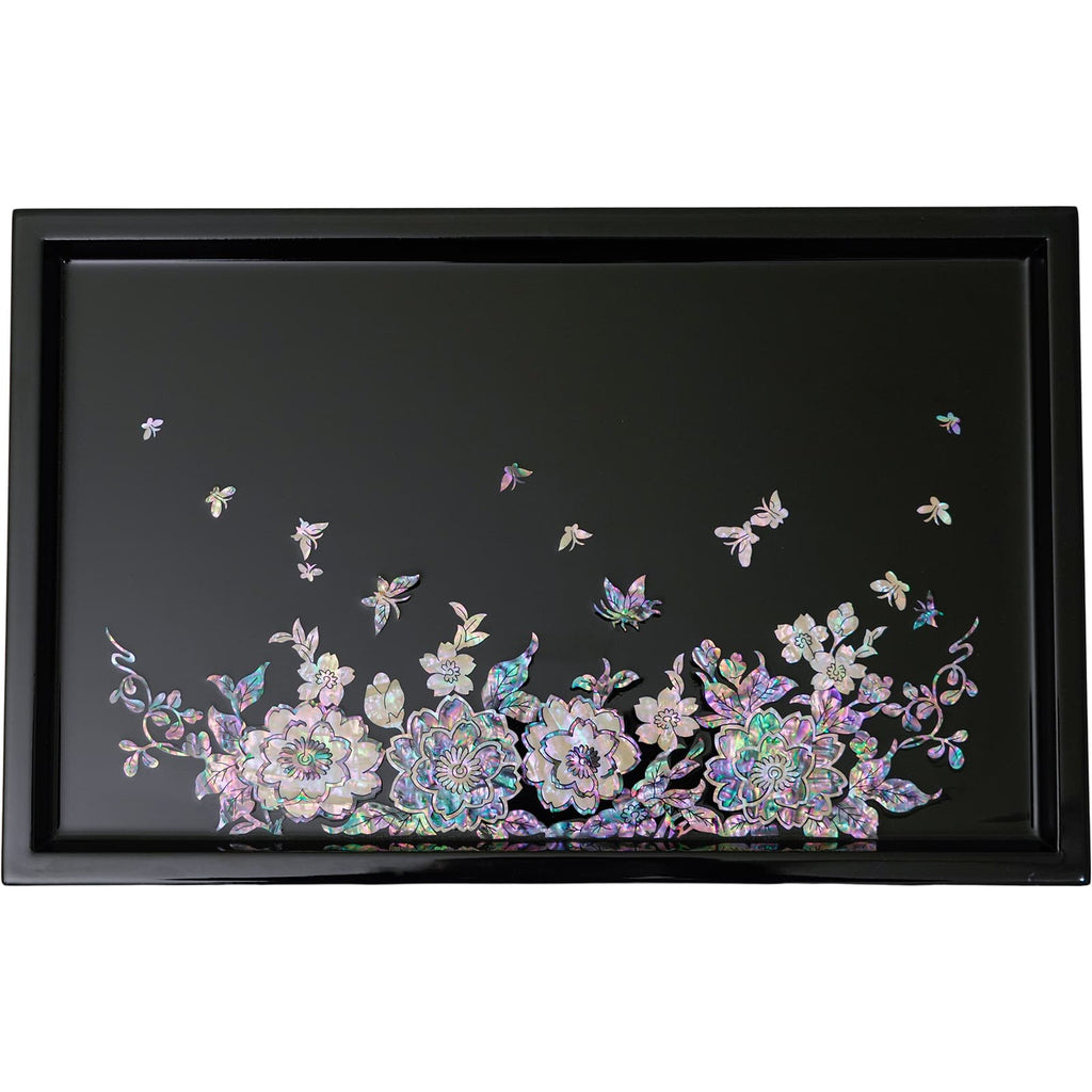 A mother-of-pearl inlaid tray with iridescent flowers and butterflies on a black background, offering a radiant and detailed design.A rectangular black tray with a vibrant Mother of Pearl inlay featuring a floral and butterfly design at the lower edge, encased by a sleek black frame.