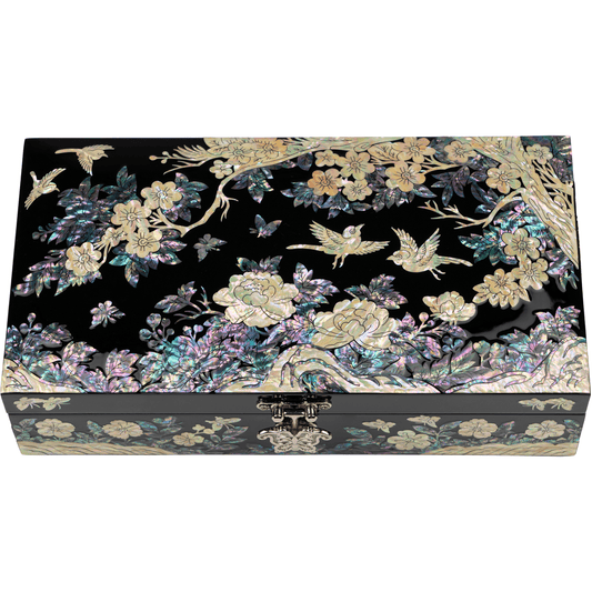 A black rectangular jewelry box with mother-of-pearl inlay depicting birds and blossoming trees, exuding a traditional and elegant aesthetic.