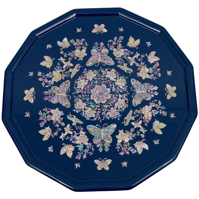 An octagonal tray with mother-of-pearl inlay featuring butterflies and flowers on a blue background.