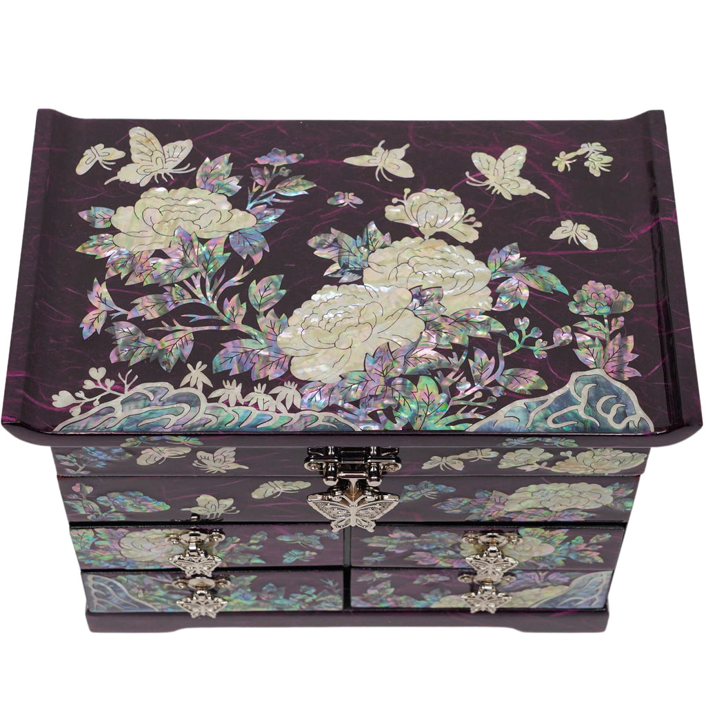 A purple mother-of-pearl jewelry box with intricate peony and butterfly designs and silver clasp. Perfect for gifting.