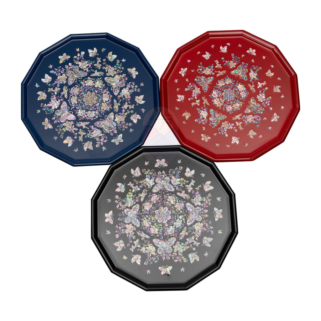The image shows three octagonal trays with mother-of-pearl inlay, each in different colors: black, blue, and red, all with floral and butterfly motifs.