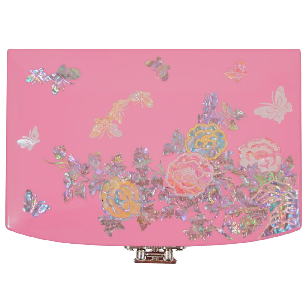 A close-up of a radiant pink jewelry box lid, embellished with delicate mother of pearl designs. Floral patterns, leaves, and ethereal butterflies in iridescent hues stand out against the pink background, creating a dreamy and elegant appearance.