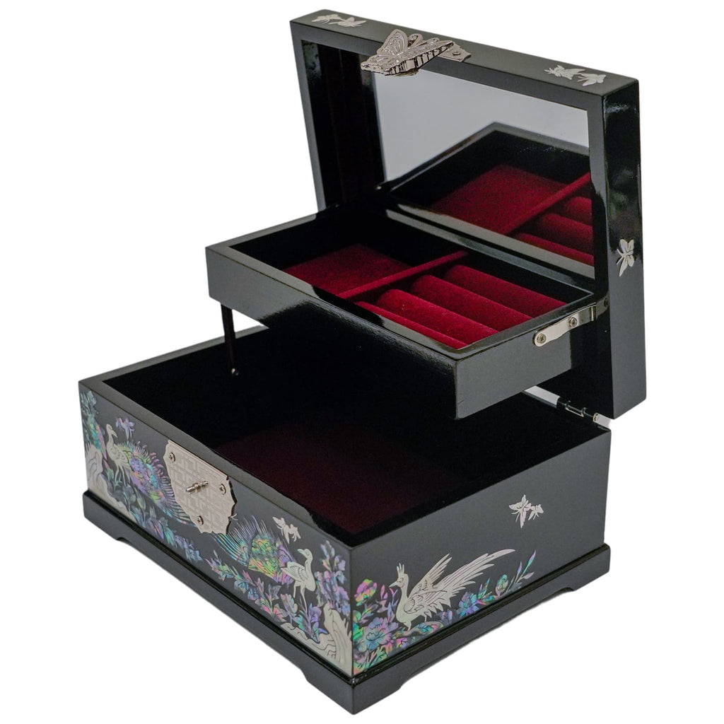 A black Mother of Pearl jewelry box with open drawers revealing red velvet lining and a mirrored lid, detailed with bird and floral motifs.