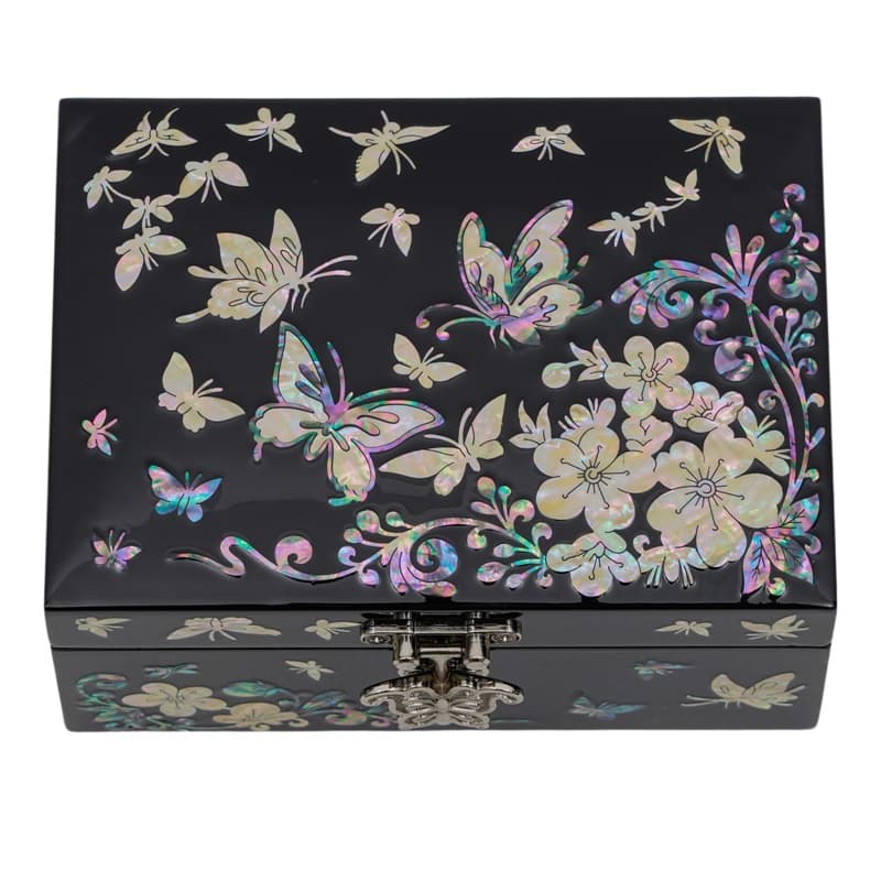 A black lacquer box with a mother-of-pearl inlay depicting butterflies and flowers, showcasing the beauty of traditional Asian art.