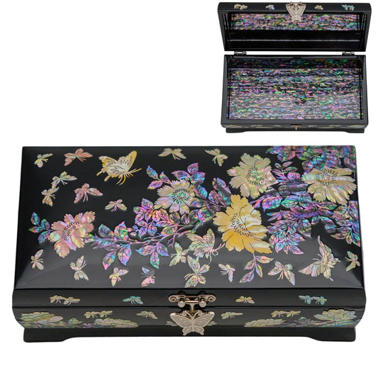 A black lacquer jewelry box with a vibrant mother-of-pearl floral design on top and front, displayed open to reveal a shimmering interior.