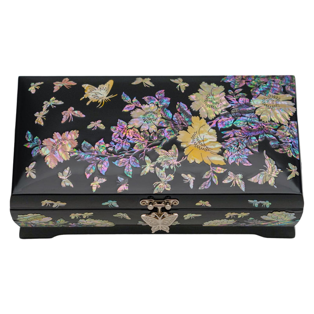 A closed black lacquer jewelry box with a colorful mother-of-pearl inlay of flowers and butterflies on the lid and a decorative clasp on the front.