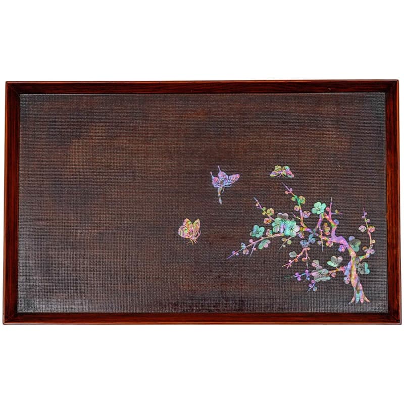 A dark brown tray with a mother-of-pearl floral design and butterflies, enclosed in a wooden frame.