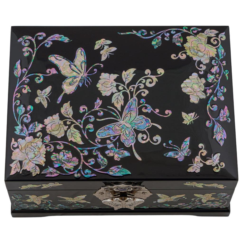 A decorative black box with iridescent mother-of-pearl inlay featuring butterflies and floral patterns, with a metal clasp on the front.