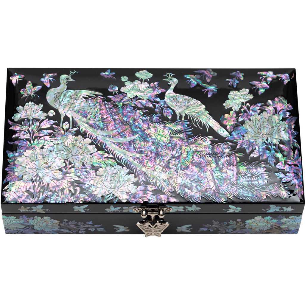 A jewelry box with a vibrant mother of pearl peacock and floral design on a black background, with a front metallic clasp.