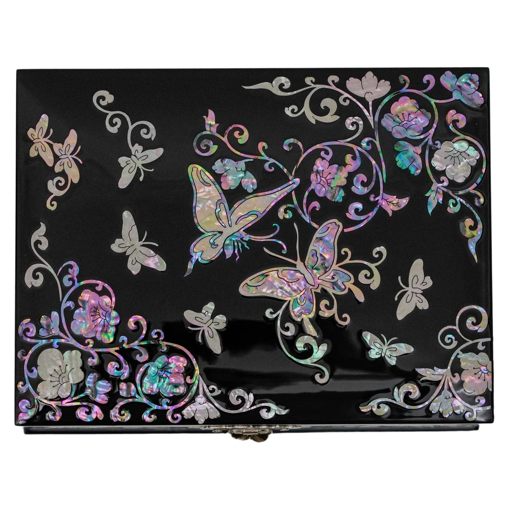 A lacquered black box adorned with shiny, multicolored mother-of-pearl inlays of butterflies and flowers, with a visible front latch.