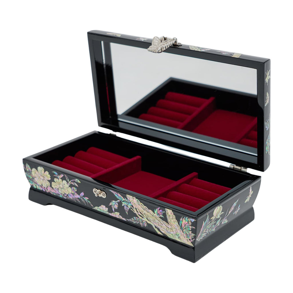 An open black jewelry box with a mirror inside the lid, red velvet compartments, and mother-of-pearl inlay on the outside with floral and butterfly motifs.